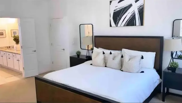 a bathroom with a granite countertop sink a mirror and shower
