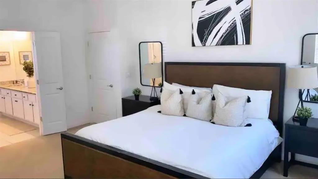 2676 Calistoga Avenue Kissimmee, FL 34741 - Photo 16 of 30 a bed room with a bed and a painting on the wall