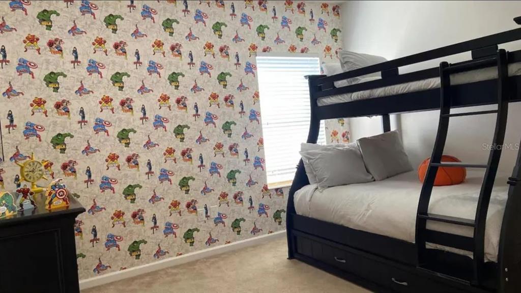 2676 Calistoga Avenue Kissimmee, FL 34741 - Photo 19 of 30 a bedroom with a bed and a chair with the shower curtain