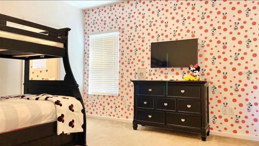 2676 Calistoga Avenue Kissimmee, FL 34741 - Photo 21 of 30 a bedroom with a bed and a flat screen tv