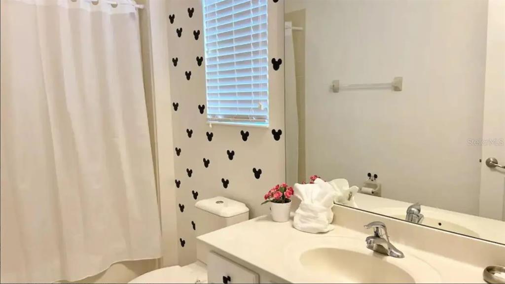2676 Calistoga Avenue Kissimmee, FL 34741 - Photo 22 of 30 a bathroom with a sink toilet and shower