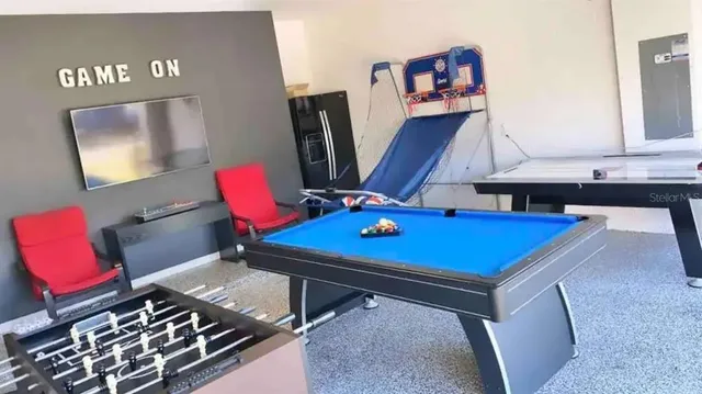 a view of swimming pool with seating area