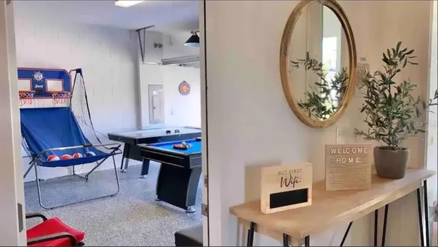 a view of hall way with furniture and paintings on the wall