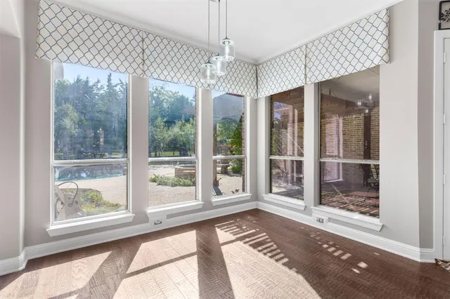 a view of a room that has a large window and a chandelier