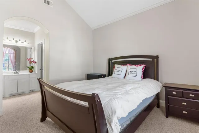 a bedroom with a bed and a dresser