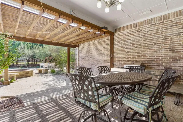 a view of a patio with a table and chairs