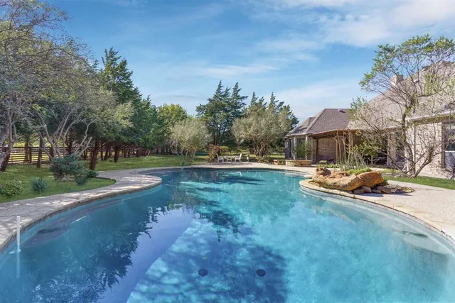a view of yard with swimming pool and sitting area
