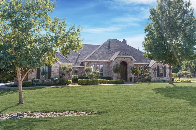 a front view of house with yard and green space