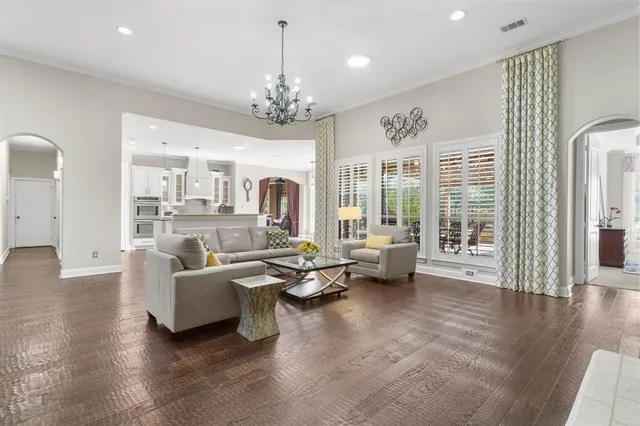 a living room with furniture couches and large windows