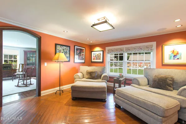 a living room with fireplace furniture and a large window