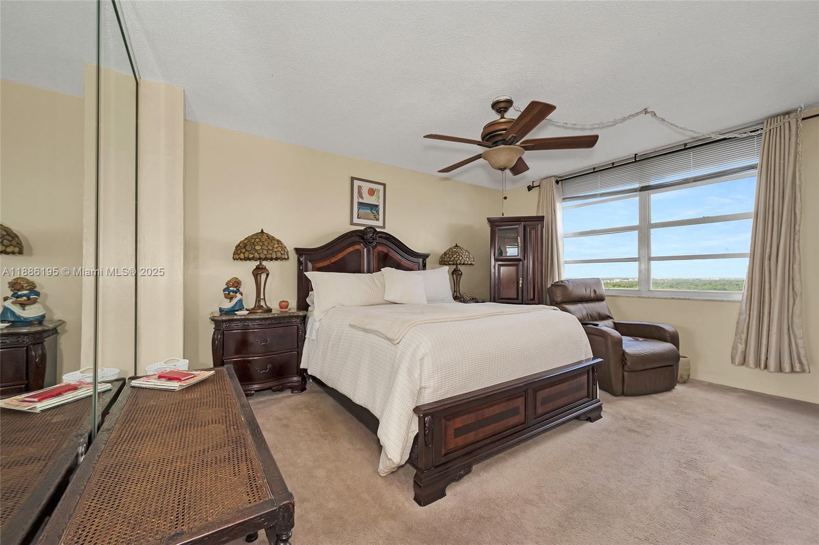 2750 Northeast 183rd Street, Unit 2204 Aventura, FL 33160 - Photo 12 of 31 a bedroom with a bed and a chandelier