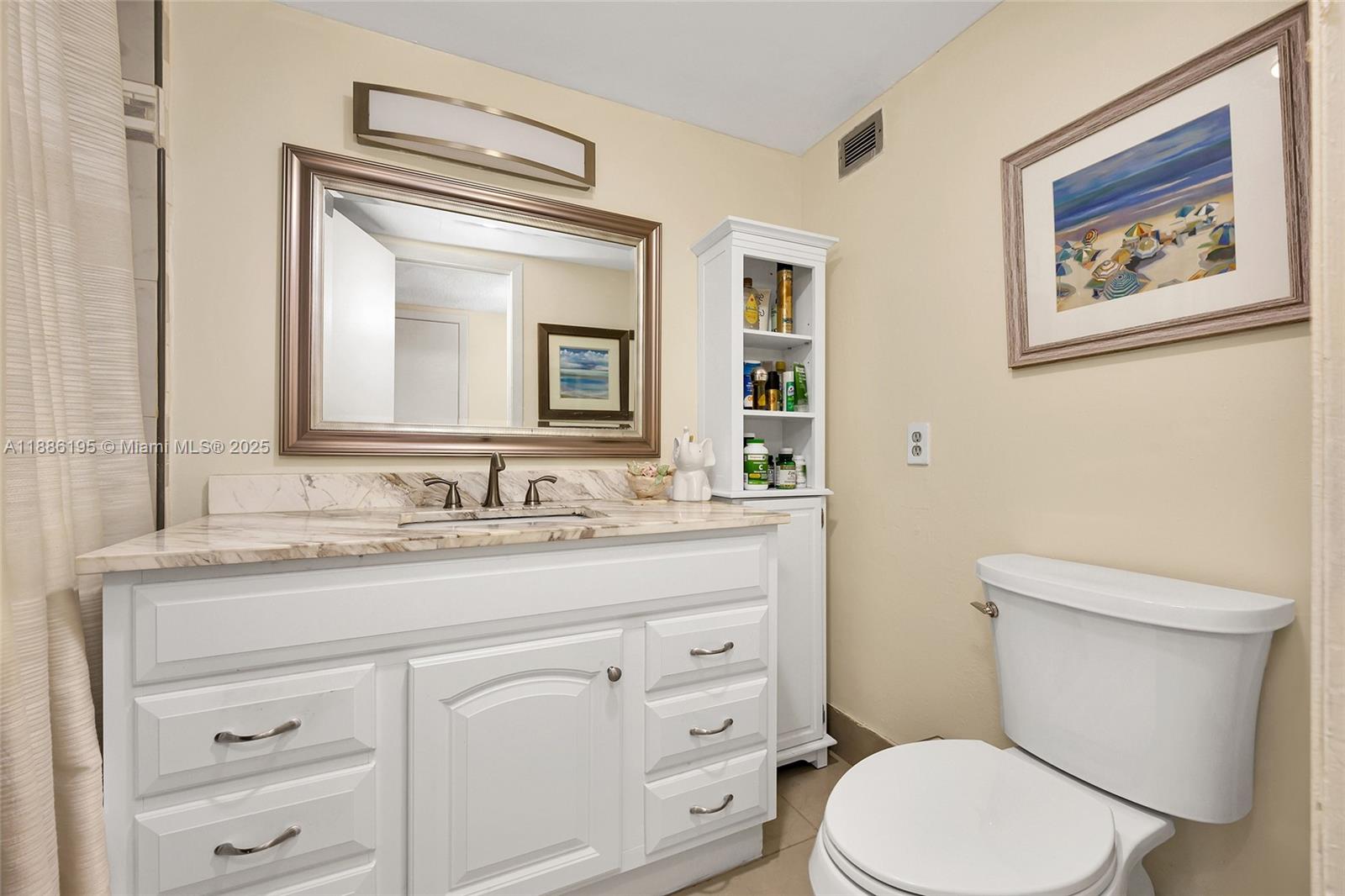 2750 Northeast 183rd Street, Unit 2204 Aventura, FL 33160 - Photo 14 of 31 a bathroom with a toilet a sink and mirror