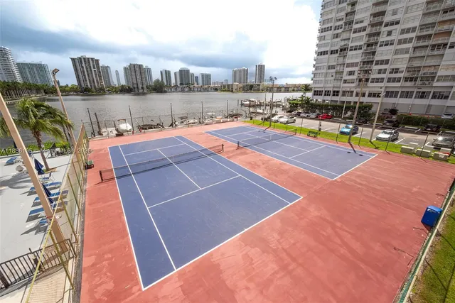 a swimming pool with outdoor seating and city view
