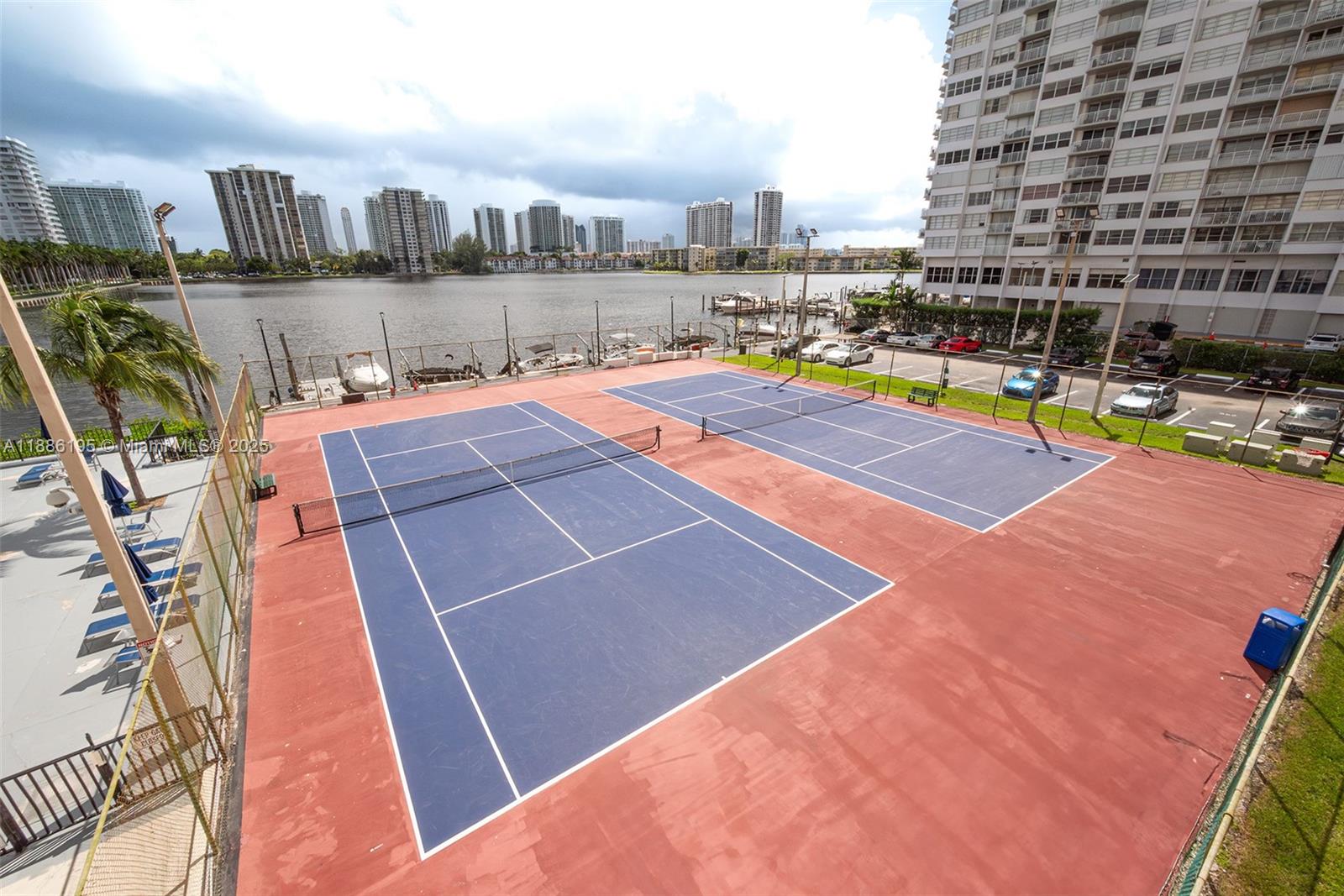 2750 Northeast 183rd Street, Unit 2204 Aventura, FL 33160 - Photo 25 of 31 a swimming pool with outdoor seating and city view