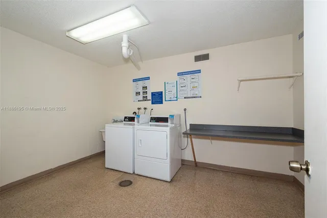a view of storage and utility room with washer and dryer