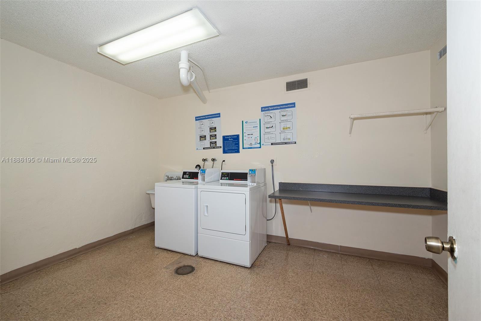 2750 Northeast 183rd Street, Unit 2204 Aventura, FL 33160 - Photo 30 of 31 a view of storage and utility room with washer and dryer