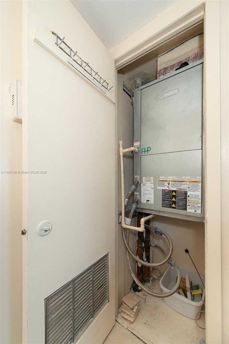 2750 Northeast 183rd Street, Unit 2204 Aventura, FL 33160 - Photo 31 of 31 a room with a washing machine and cabinets