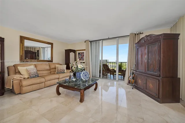 a living room with furniture and a refrigerator