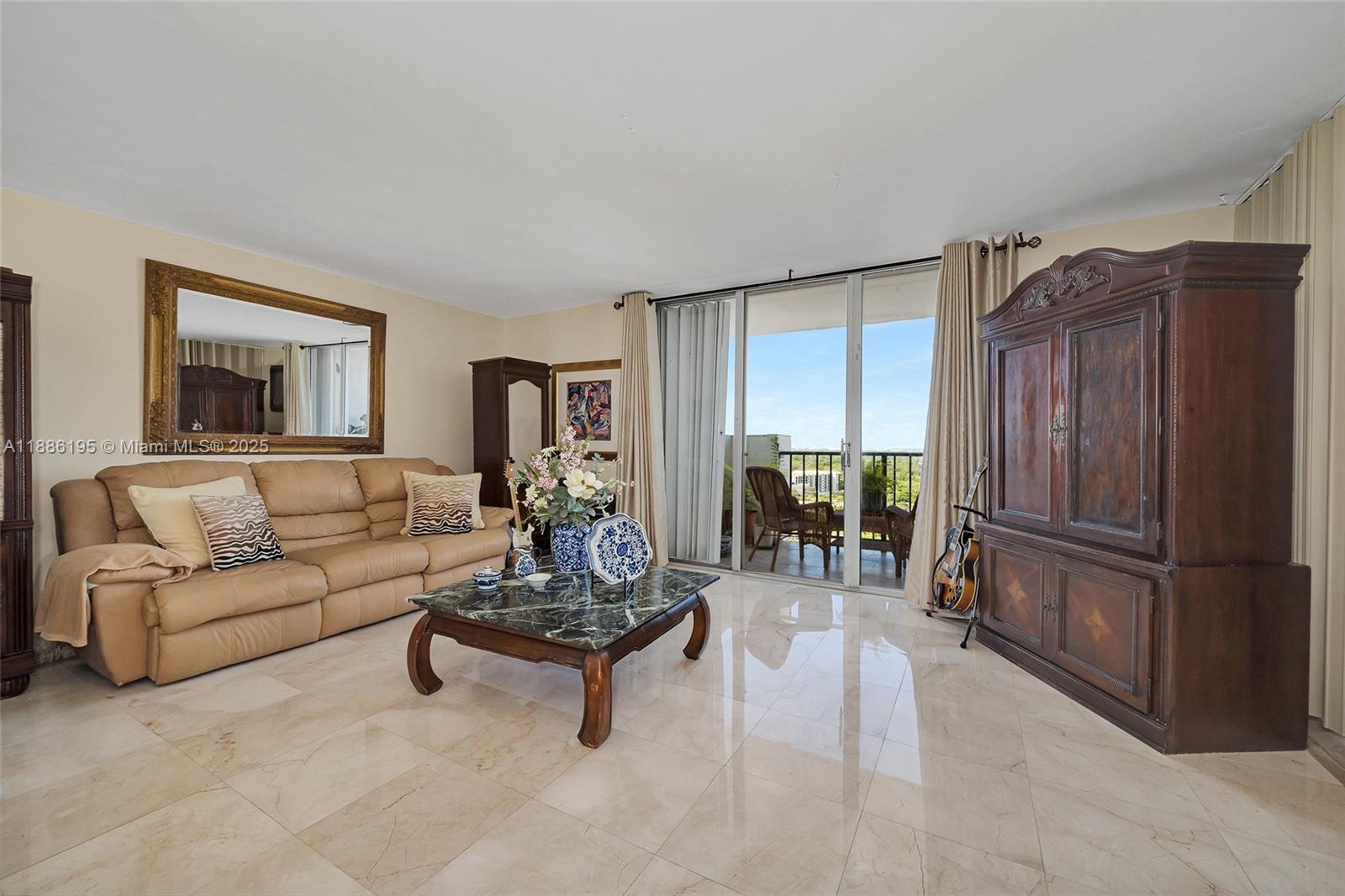 2750 Northeast 183rd Street, Unit 2204 Aventura, FL 33160 - Photo 4 of 31 a living room with furniture and a refrigerator
