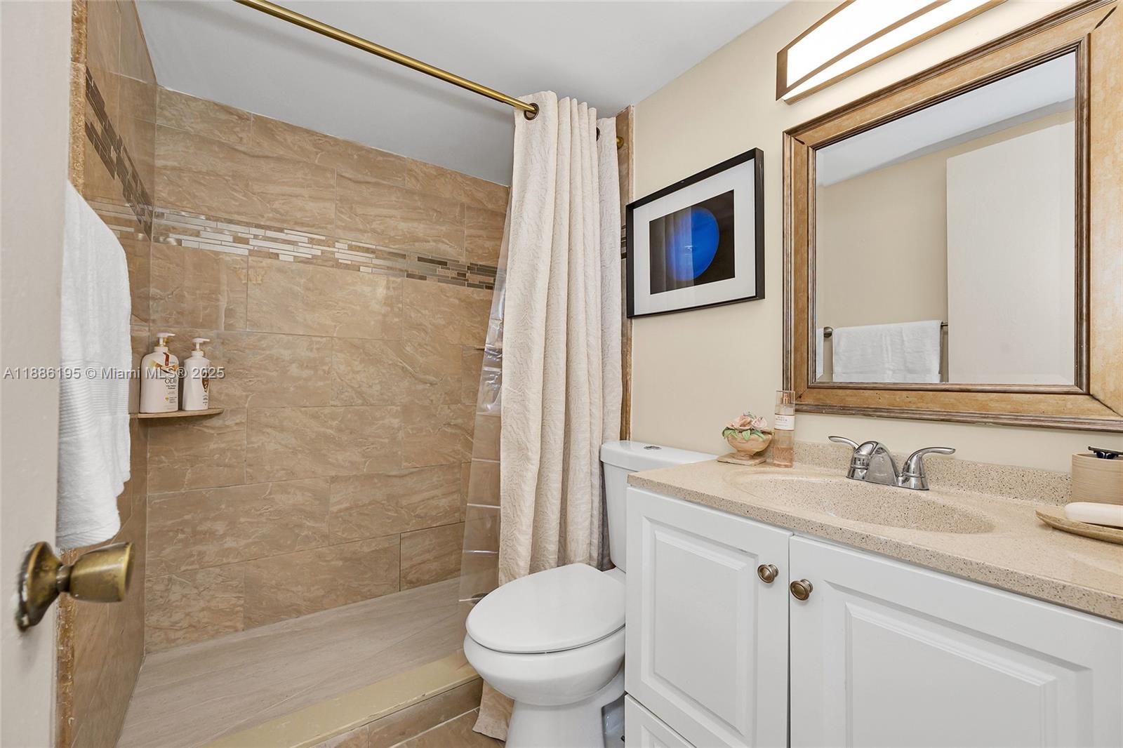 2750 Northeast 183rd Street, Unit 2204 Aventura, FL 33160 - Photo 10 of 31 a bathroom with a sink toilet and shower