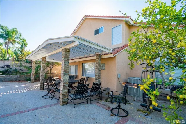 a view of a patio with table and chairs and potted plants