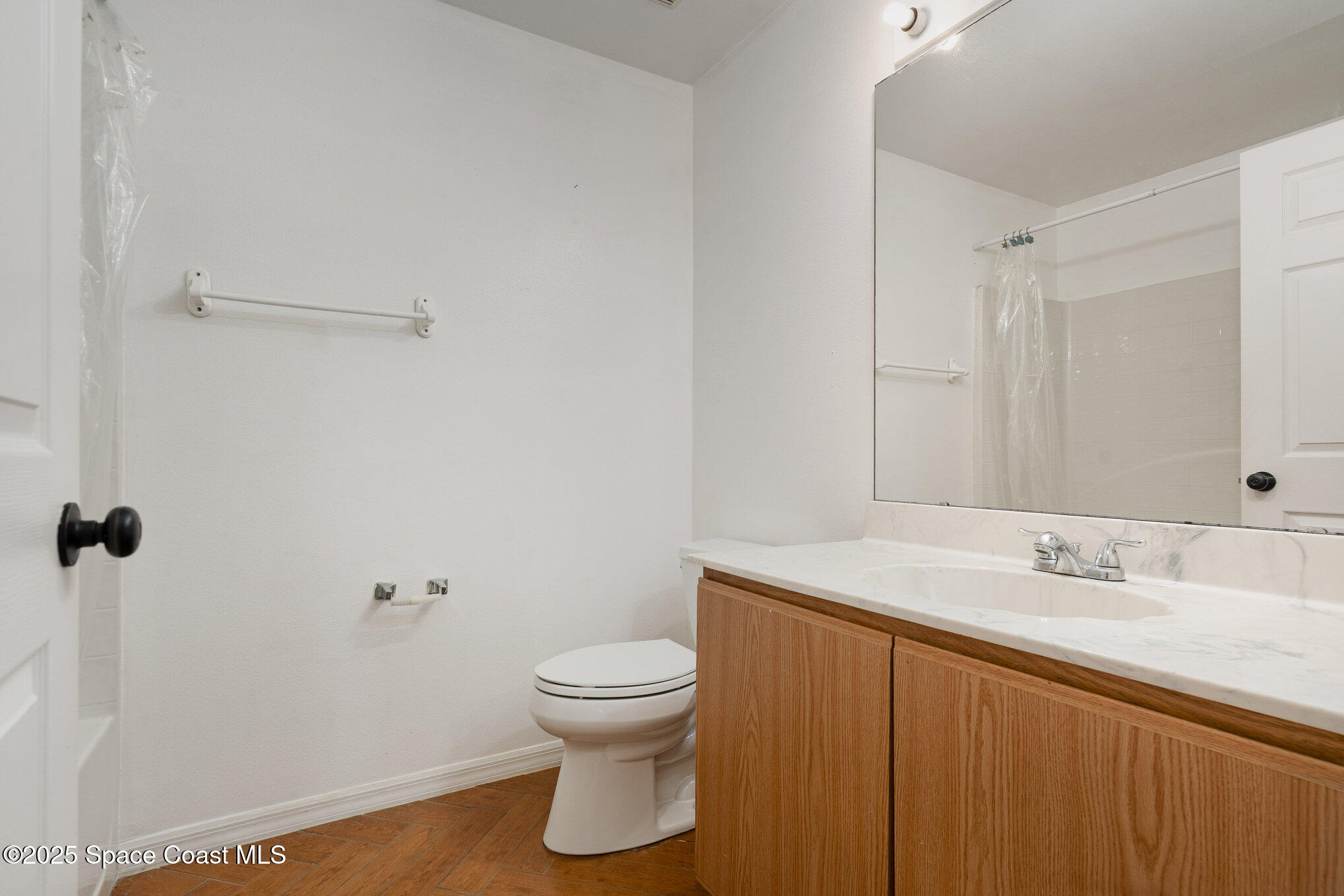 2885 Maderia Circle Melbourne, FL 32935 - Photo 12 of 15 a bathroom with a sink toilet and vanity