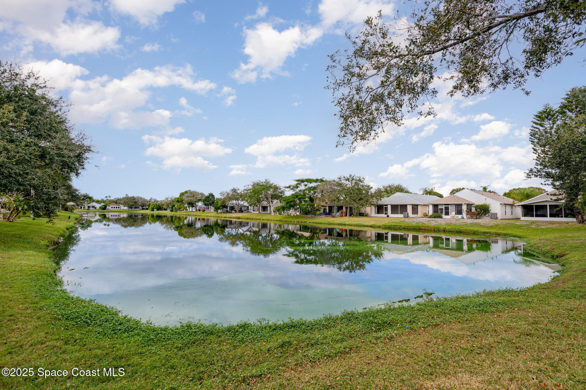 2885 Maderia Circle Melbourne, FL 32935 - Photo 15 of 15 a view of a lake with houses