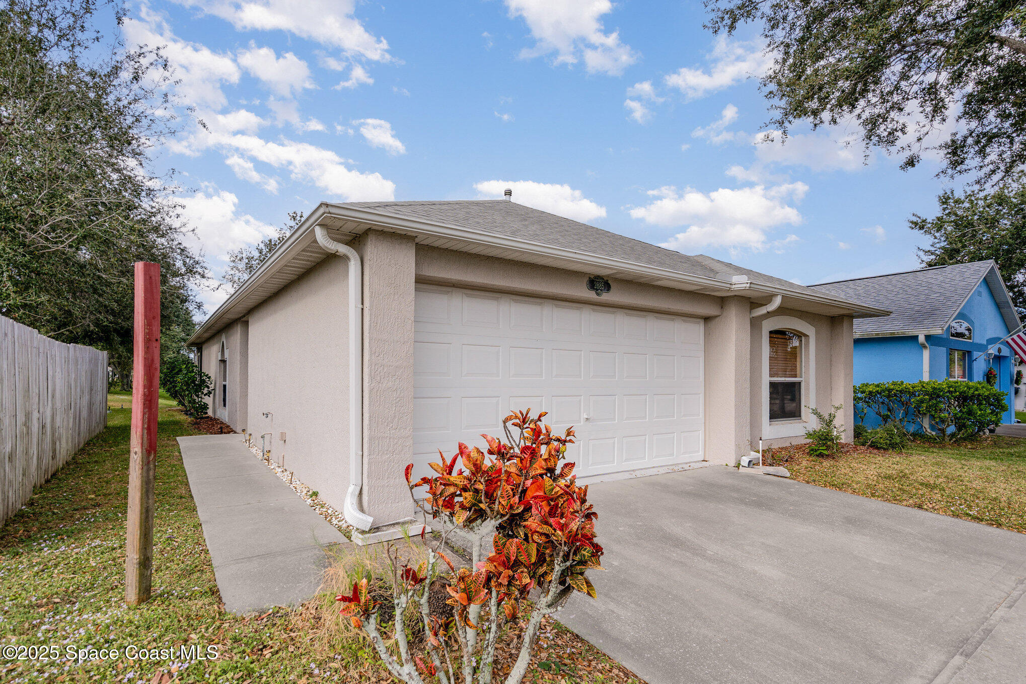 2885 Maderia Circle Melbourne, FL 32935 - Photo 2 of 15 a front view of a house with a yard