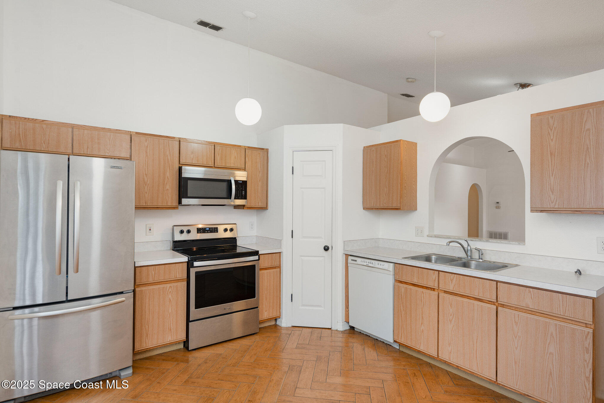 2885 Maderia Circle Melbourne, FL 32935 - Photo 3 of 15 a kitchen with stainless steel appliances a refrigerator sink and microwave