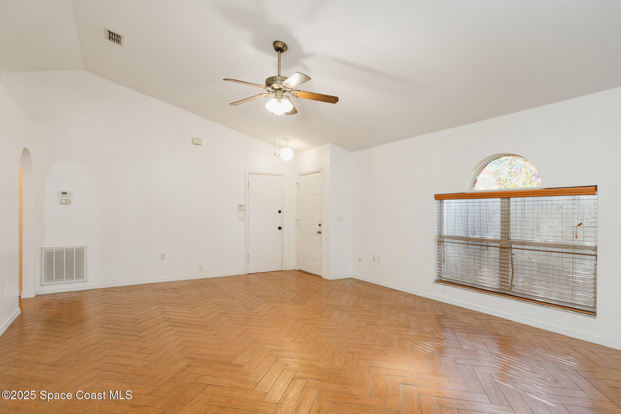 2885 Maderia Circle Melbourne, FL 32935 - Photo 4 of 15 a view of an empty room with a window and cabinet