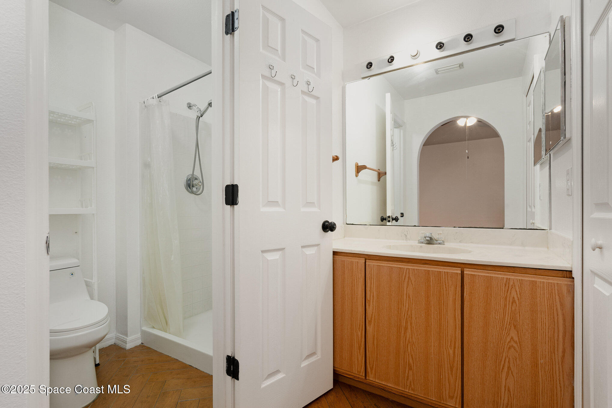2885 Maderia Circle Melbourne, FL 32935 - Photo 8 of 15 a bathroom with a sink a toilet and shower