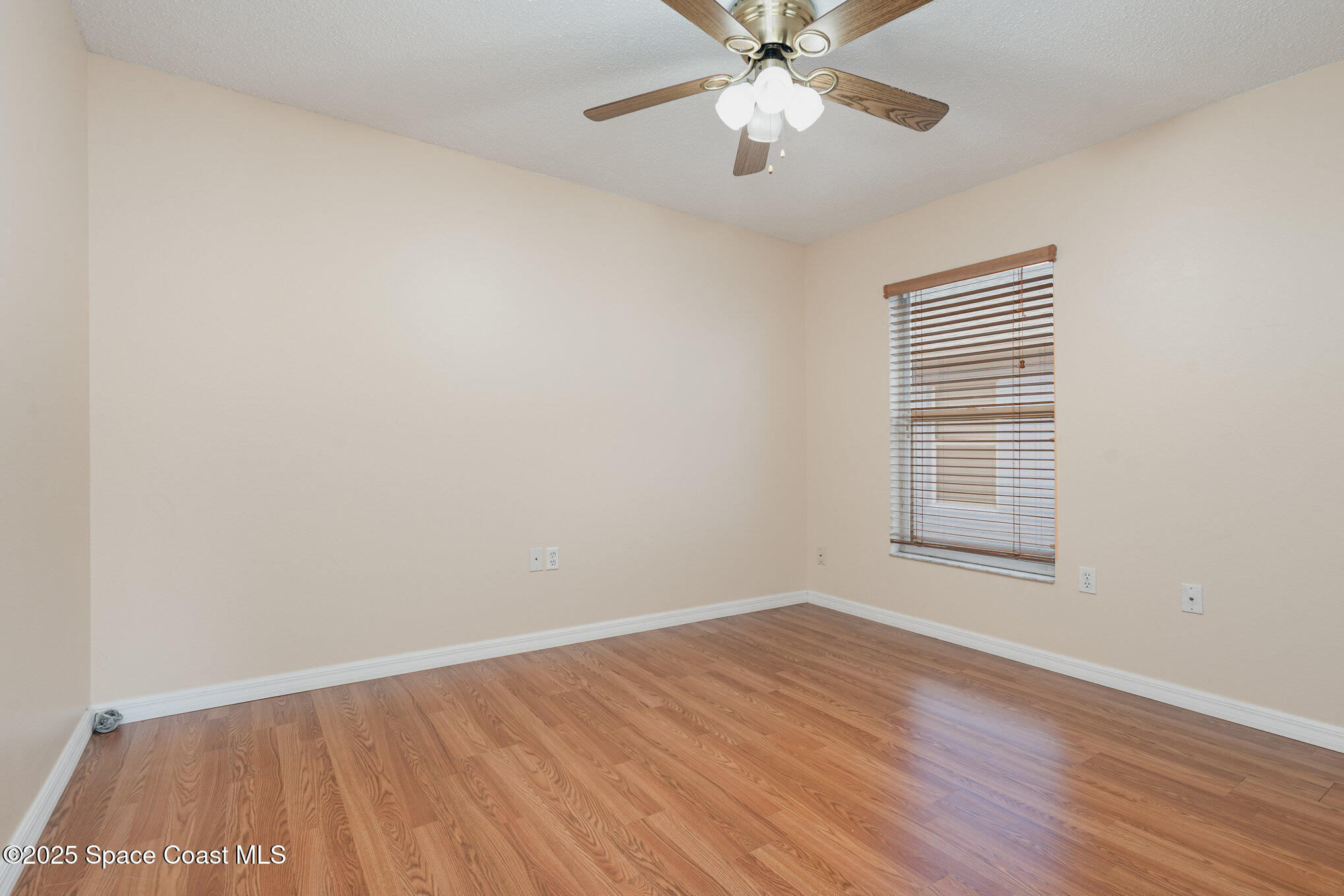 2885 Maderia Circle Melbourne, FL 32935 - Photo 9 of 15 wooden floor in an empty room with a window