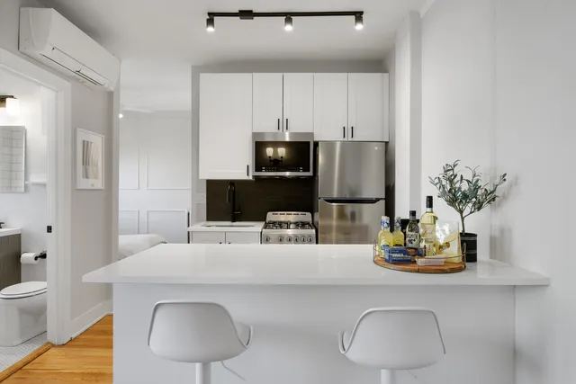 a kitchen with a table and chairs