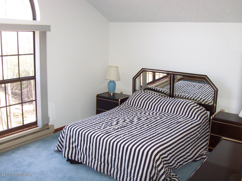 53 Crestview Road Blakeslee, PA 18610 - Photo 8 of 10 a bedroom with a bed and wooden floor