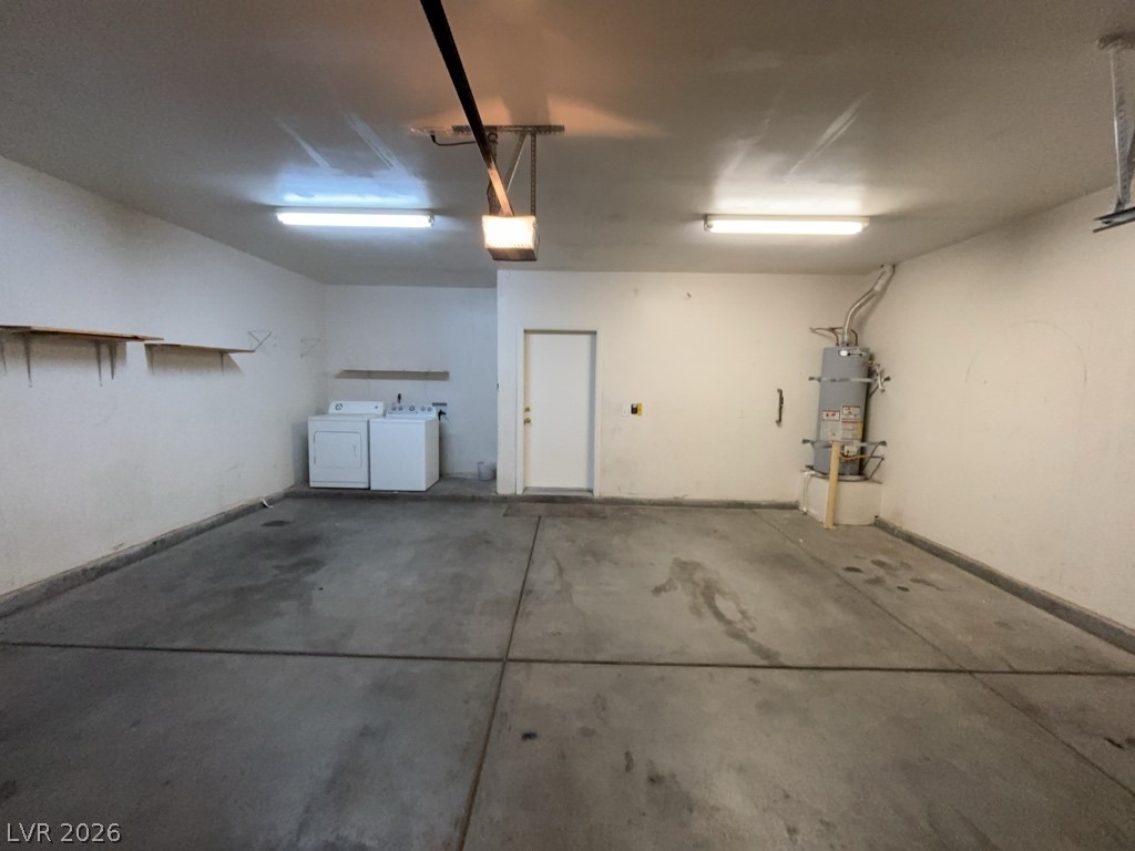 4915 East Russell Road, Unit 147 Las Vegas, NV 89120 - Photo 14 of 14 Garage with separate washer and dryer, strapped water heater, and a garage door opener