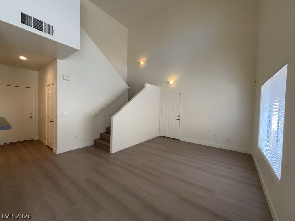 4915 East Russell Road, Unit 147 Las Vegas, NV 89120 - Photo 4 of 14 Unfurnished living room with dark wood finished floors, a high ceiling, and recessed lighting