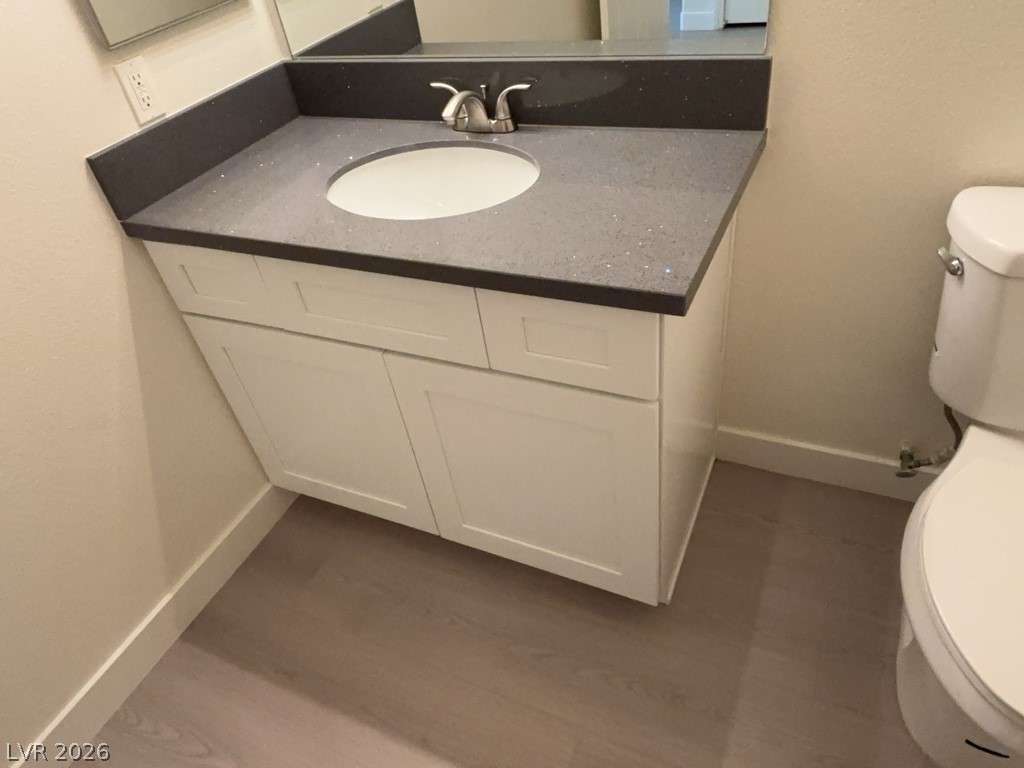 4915 East Russell Road, Unit 147 Las Vegas, NV 89120 - Photo 9 of 14 Half bathroom with vanity and dark wood-style floors