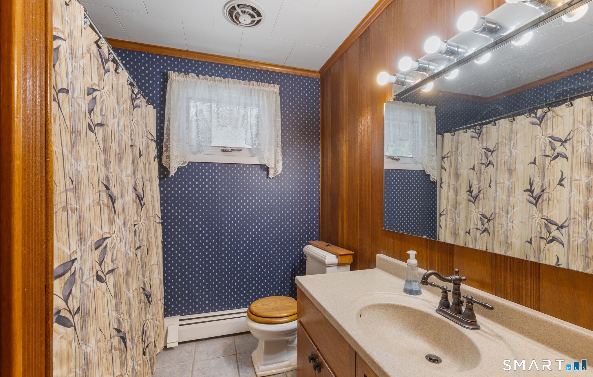 52 North Glenwoods Road Ledyard, CT 06335 - Photo 16 of 27 a bathroom with a sink and mirror with toilet