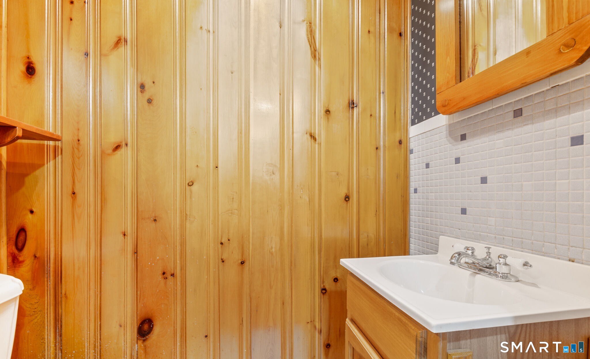 52 North Glenwoods Road Ledyard, CT 06335 - Photo 22 of 27 a bathroom with a sink a mirror and a shower curtain