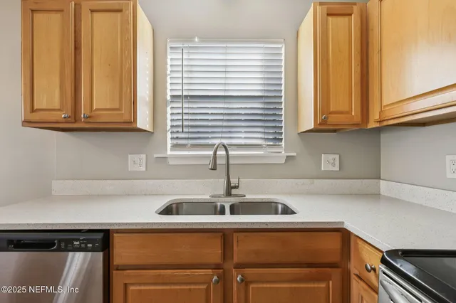 a kitchen with a sink cabinets and a window