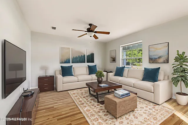 a living room with furniture a rug and a flat screen tv