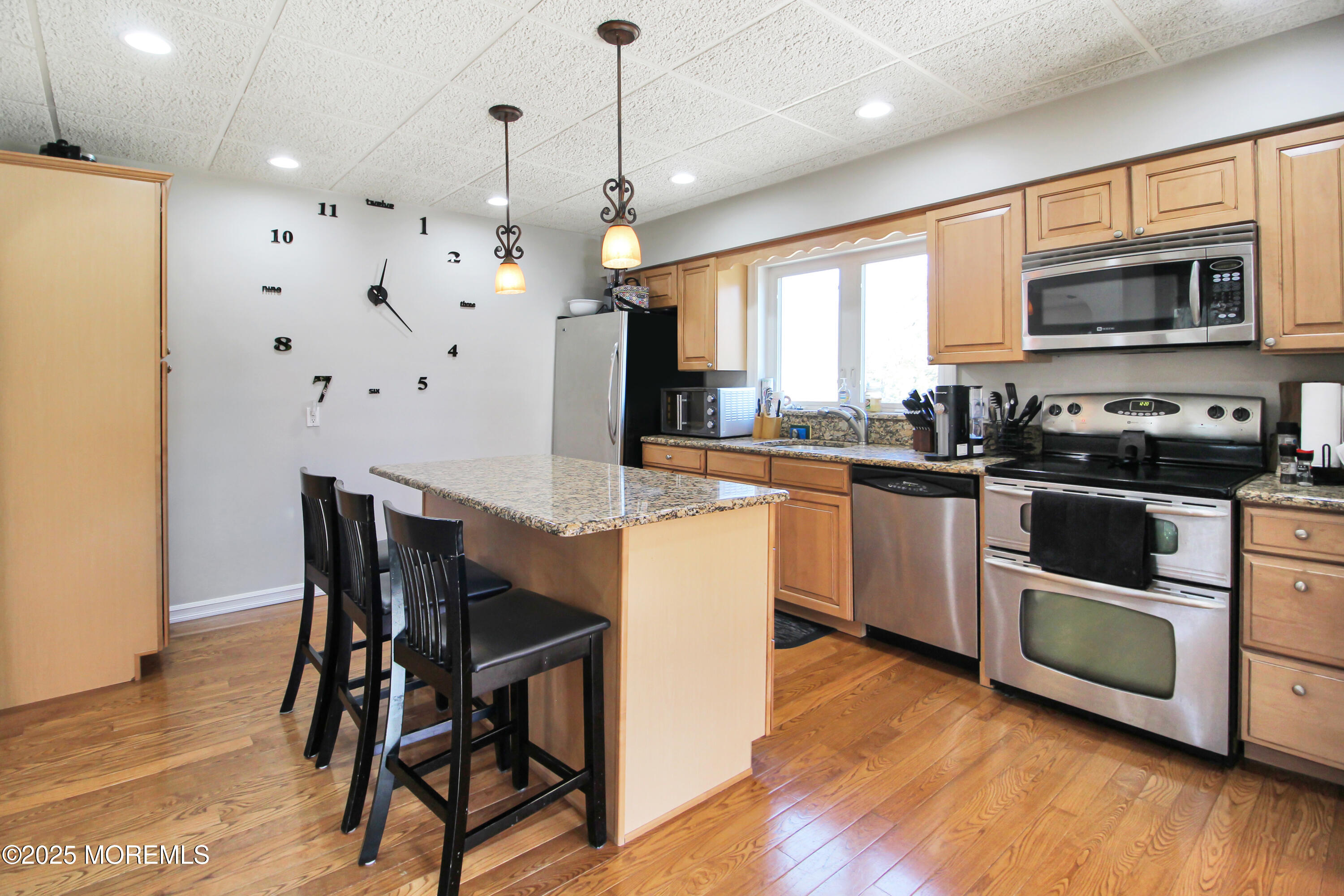 Cassville Road Jackson, NJ 08527 - Photo 10 of 22 a kitchen with stainless steel appliances granite countertop wooden floors and white cabinets