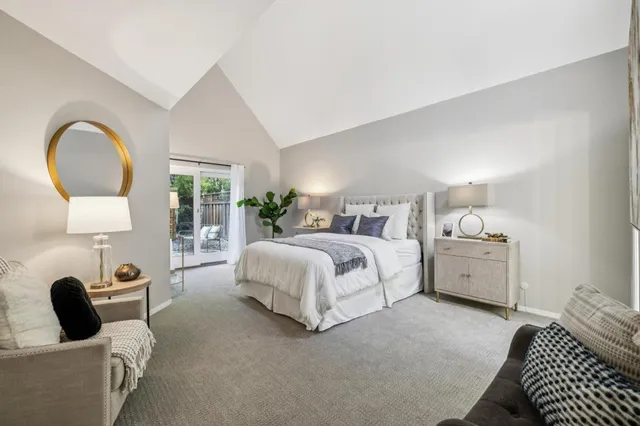 a bedroom with a bed and a large window