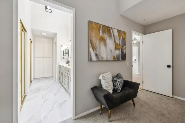 a living room with furniture and a painting on the wall