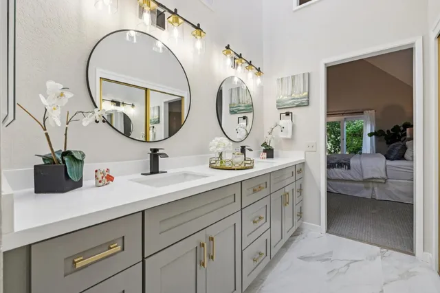 a bathroom with a double vanity sink and a mirror