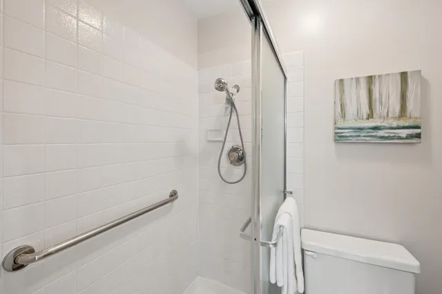 a bathroom with a shower a toilet and a shower