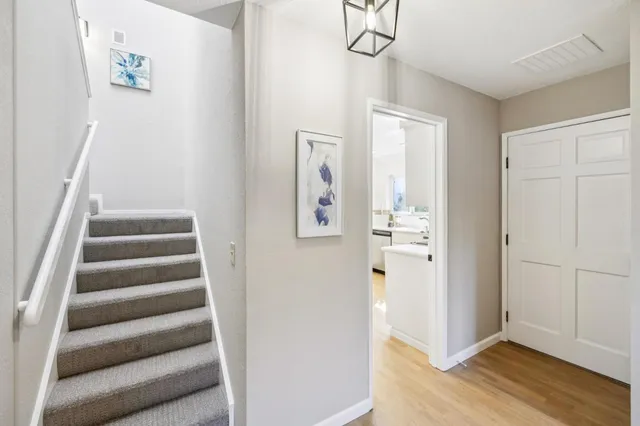 a view of a hallway with wooden floor and entryway