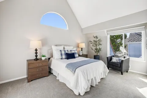 a bedroom with a bed and a couch