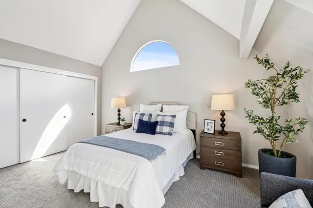 a bedroom with bed and a potted plant