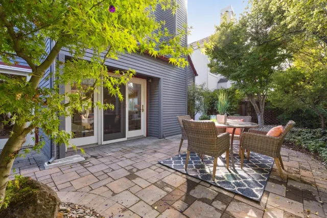 a view of a patio with table and chairs and potted plants